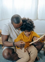 A man is holding his child