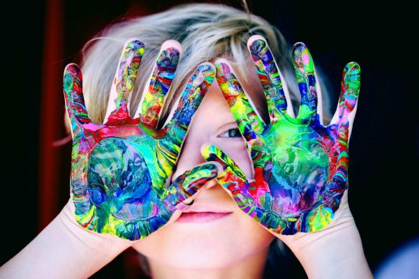 A child with paint on their hands