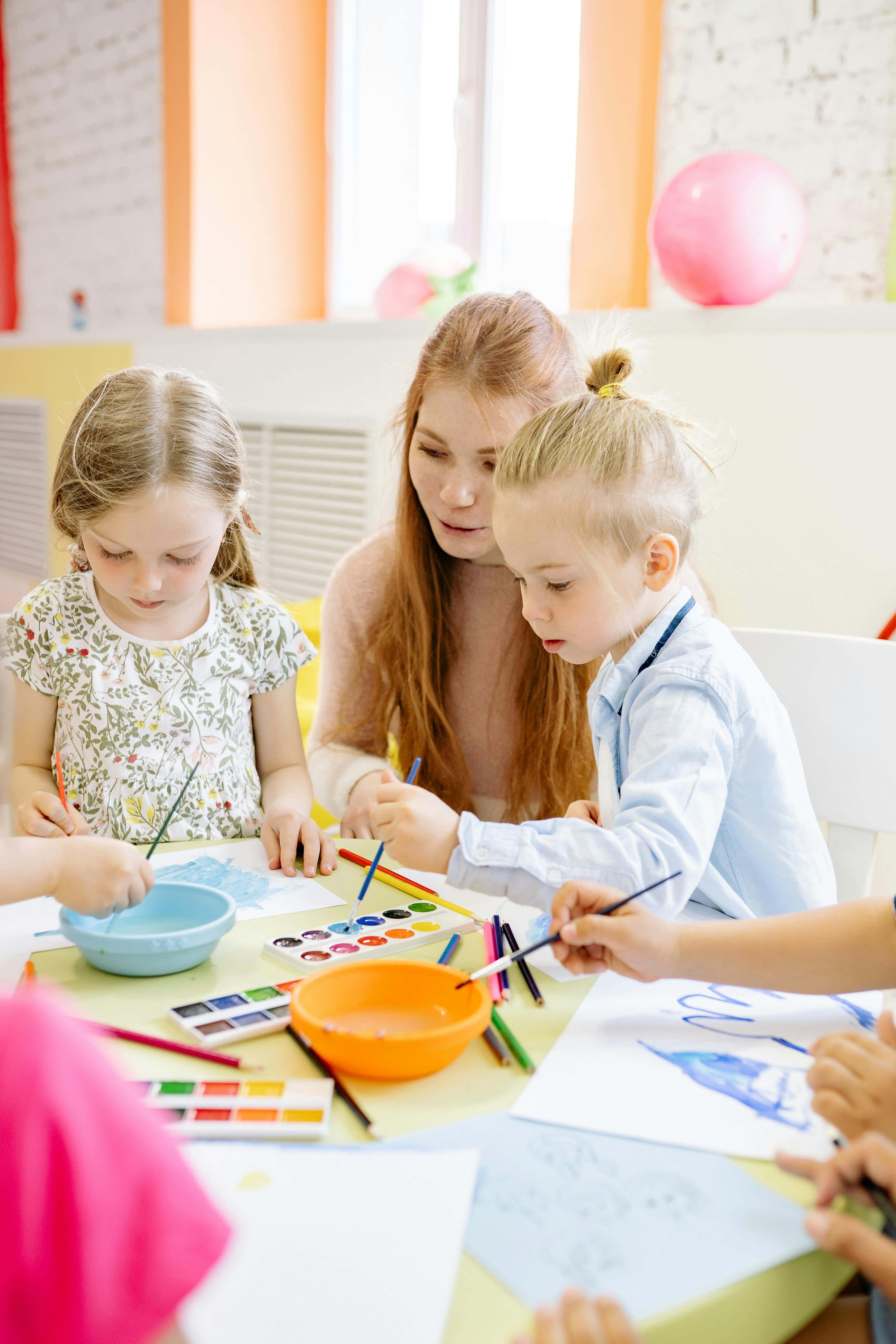 A young girl is doing crafts